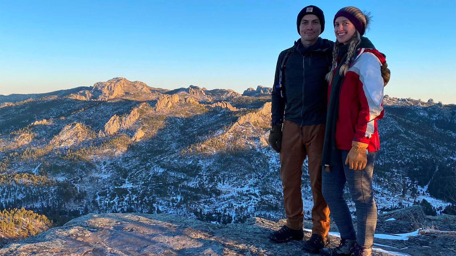 Courtney Keiser and her significant other standing at the top of Saint Elmo Peak in the Black Hills. They love camping and hiking out there.