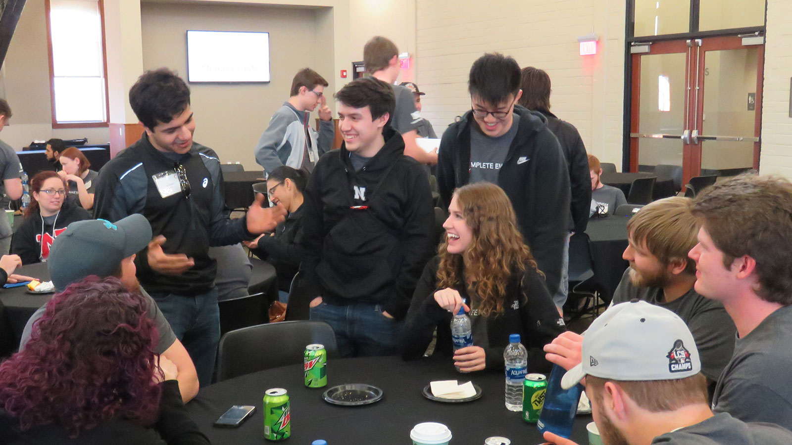 Students sitting in a group laughing.