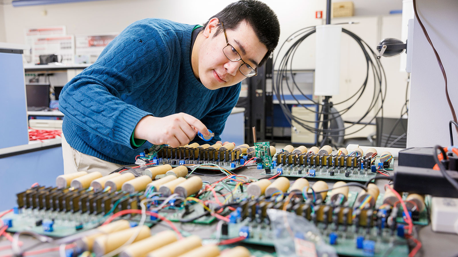 Man working with an electrical board.