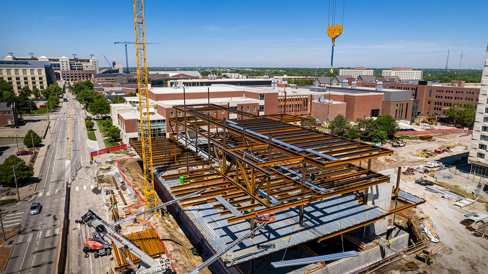 View of Kiewit Hall (under construction) from above, looking west down Vine Street with Memorial Stadium in the background.