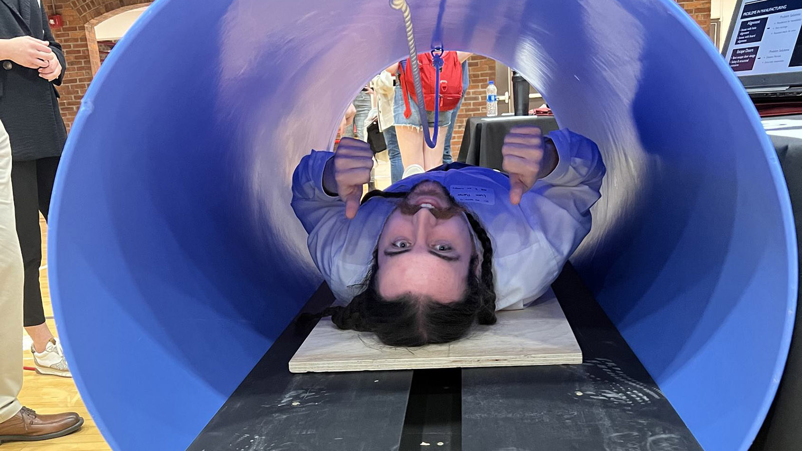 Student in a large blue tube
