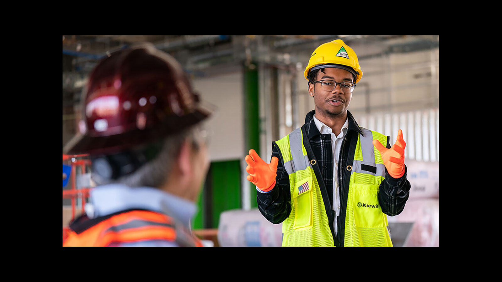 Nebraska's Andre Tharp III gestures as he talks with Dean Lance C. Pérez during a recent tour of Kiewit Hall construction. (University Communication and Marketing)