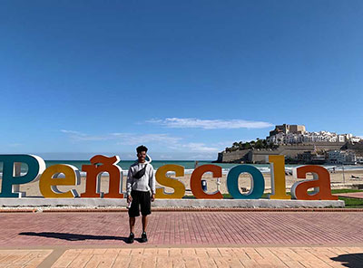 Andre' Tharp standing in front of the Penascola sign