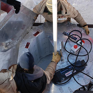 The WISSARD research team set up an ultraviolet light collar at the top of the bore hole in Antarctica. (Photo by Frank Rack, UNL Science Management Office) 