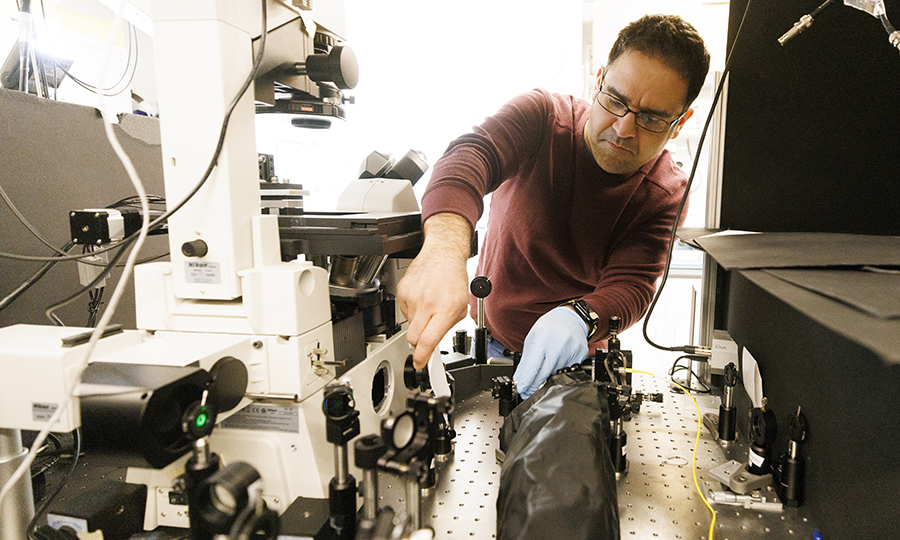Postdoctoral researcher Mohammadjavad Dowran works with diamond quantum sensing microscopes in Abdelghani Laraoui’s lab. (Craig Chandler / University Communication &amp; Marketing)