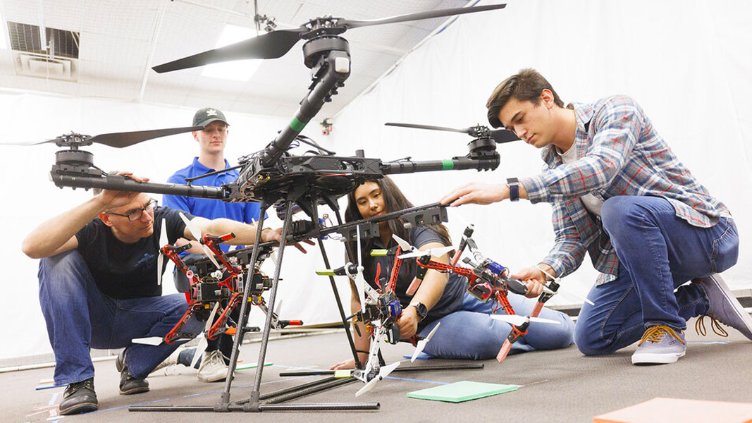Students working together on a large drone.