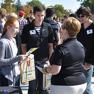 UNL first-year engineering students discuss employment opportunities with a representative of the Nebraska Public Power District during a career fair at Veterans Memorial Field in Norfolk on Oct. 9.