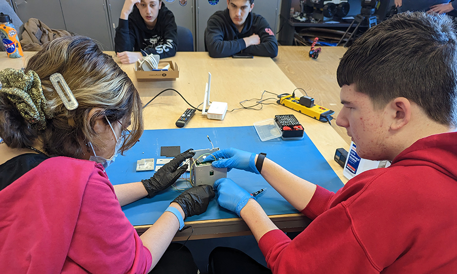 Students on the Big Red Satellite Team work on their CubeSat satellite, which will be launched into space this March and later deployed from the International Space Station.