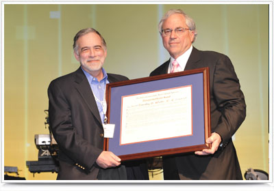 Tim Wentz (left), associate professor of construction management with Nebraska Engineering, receives the Distinguished Service Award from MCAA President Jack Wilhelmi.