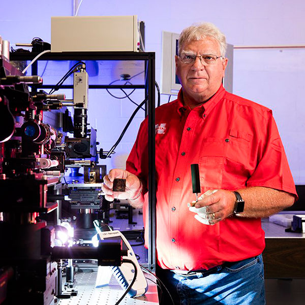 Dennis Alexander, Kingery Professor of Electrical and Computer Engineering, uses a femtosecond laser to replicate biological structures on metal surfaces.