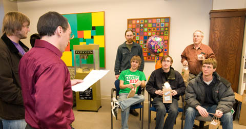 Steve Goddard (left), chair of computer science and engineering, reads a statement of good luck to members of the computer programming team that will compete in the Association for Computing Machinery International Collegiate Programming Contest. Team members include (back row) Jeff Ifland, assistant coach; and Charles Riedesel, coach of the team and assistant professor of practice. Photo by Greg Nathan/University Communications.