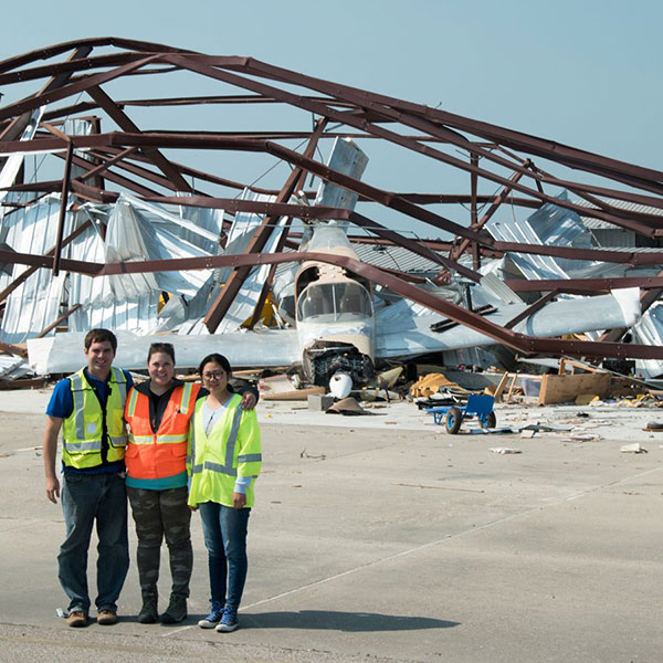 Richard Wood (left), assistant professor of civil engineering; and Yijun Liao (right), Ph.D. student in civil engineering, were joined by Kara Peterman of the University of Massachusetts-Amherst in assessing damage at the Aransas County Airport in Rockport, Texas.