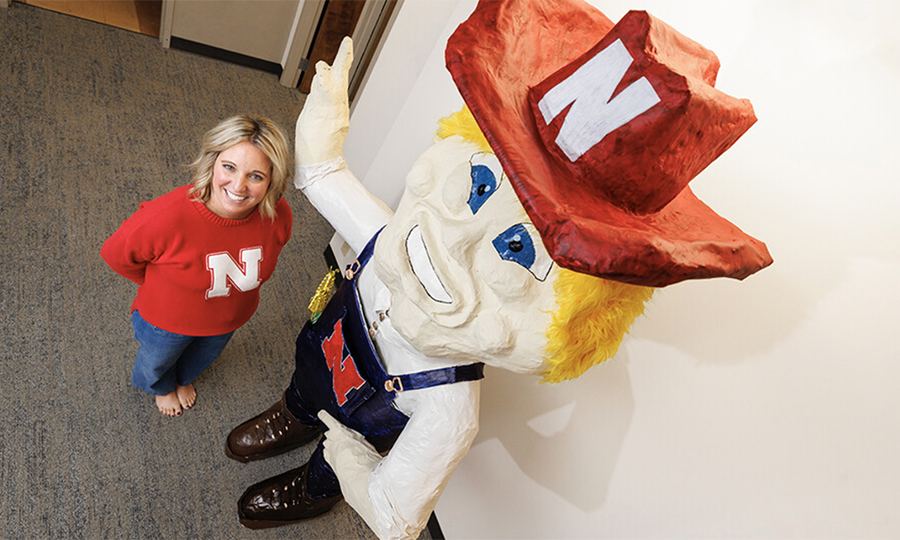 Ashley Dohe, administrative coordinator for Electrical and Computer Engineering, has make an 8-foot tall Herbie Husker from papier mâché. She hopes to auction it off to help veterans. (Craig Chandler / University Communication and Marketing)