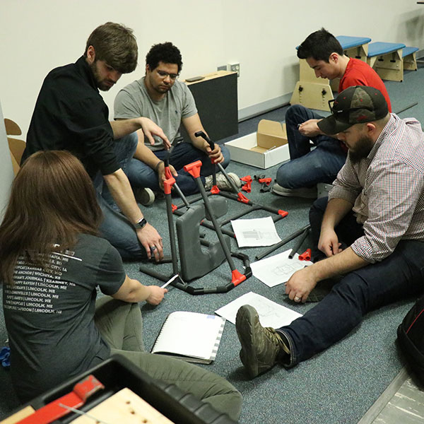 A team of mechanical and materials engineering students -- (from left) Samone Hinsley, Daniel Carlson, Mohamed Hussein, Colby Kubik and Ricardo Villegas Martinez -- put together the pediatric shower chair designed for their senior design capstone project.