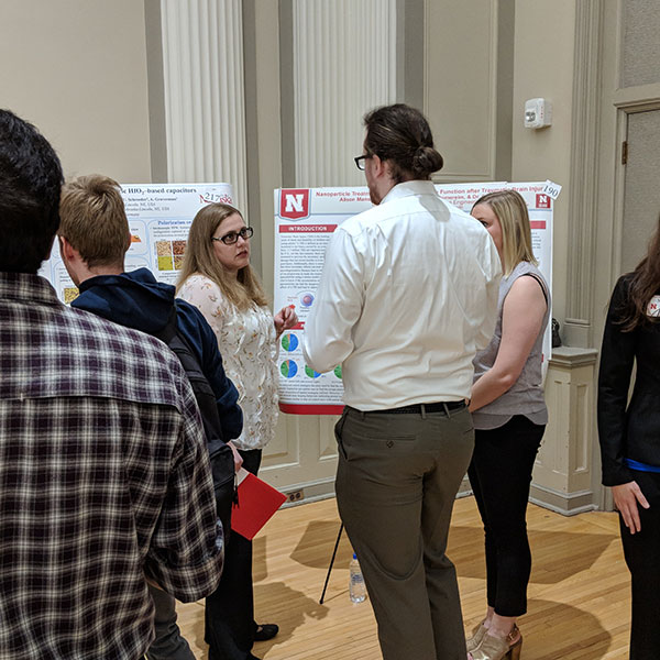 Connor Gee (center) and Allison Manske (right), biological systems engineering students, discuss their project with Nicole Iverson, assistant professor of biological systems engineering.