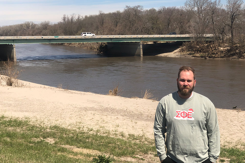 Kyle Rotert, a senior in architectural engineering, stands on the levee near the Maple Street bridge in Waterloo. In March, the Elkhorn River surged more than 5 feet above flood stage. Rotert said he learned plenty about engineering by helping to monitor the levees during those hectic days.