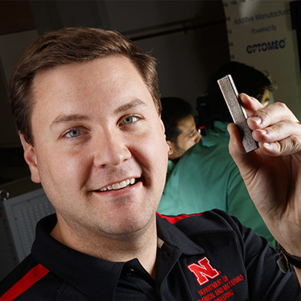 Michael Sealy, assistant professor of mechanical and materials engineering, holds a basic example of the medical implants he's designing via the University of Nebraska-Lincoln's 3D printers. Sealy is using the printers to build magnesium-based screws, pins and other implants that can slowly dissolve in the body, which would negate the need for follow-up surgeries to remove such implants.