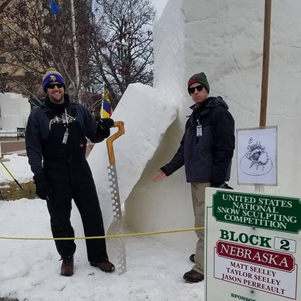 Civil engineering student Taylor Seeley (right) and Jason Perreault begin work on their 9-foot cylinder of snow on Wednesday in Lake Geneva, Wisconsin.