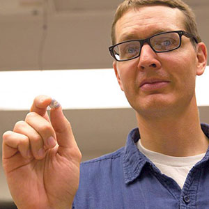 Benjamin Terry, assistant professor of mechanical and materials engineering, holds a prototype of his team's tapeworm-inspired attachment mechanism. The device adhered to the wall of a live intestine for six days.