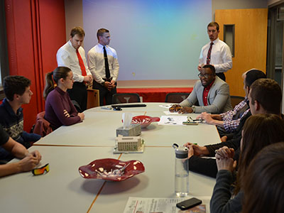 J.K. Osiri, director of UNL's international business program and associate professor of practice in management, meets with engineering and business students to discuss the team's project to help the Kinawataka Women Initiatives in Kampala, Uganda.