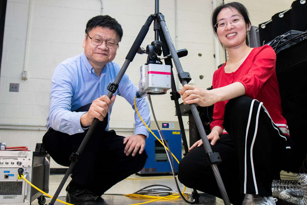 Yongfeng Lu (left) and doctoral student Lei Liu with a portable laser that helps prevent and repair corrosion on aluminum-sided ships. (Photo by NUtech Ventures)