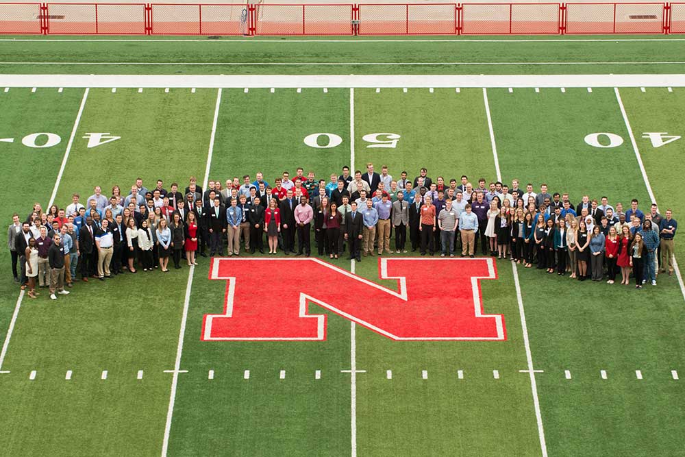 Before the April 21 Senior Design Showcase, members of 46 College of Engineering senior design capstone teams gather for a group picture on the field at Memorial Stadium.
