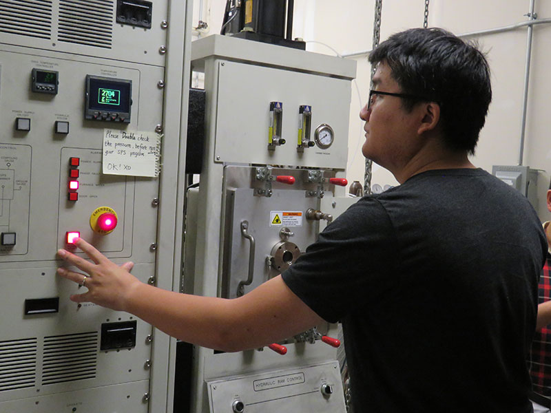 Xueliang Yan, postdoctoral researcher, operates a machine that allows high-temperature testing of materials that Bai Cui's team is developing for use in the next generation of nuclear reactors.