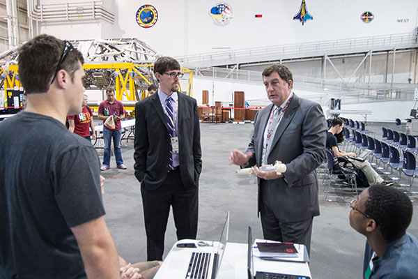 NASA engineers from Johnson Space Center in Houston, Texas, give feedback on the sample collection tool designed by the UNL Air and Space Research team.