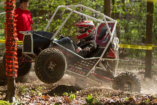 Driver Eric Rice tries to maneuver the Husker Racing Baja SAE team over a log obstacle during the endurance race at the Cookeville, Tennessee, event in April.