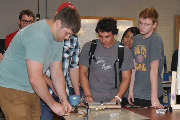 Team nine - which included Mary Hernandez, David Marshall, Jacob Meyer, Lukas Samuelson and Jared Thomsen -- prepares its entry in the Rapid Design Challenge.