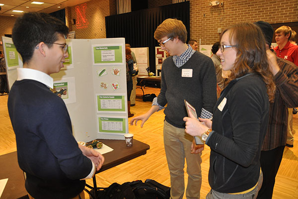 Judges interview students about their projects and evaluated their posters that detailed the process of constructing cars for the Incredible, Edible Vehicle Competition.
