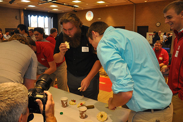 Caleb Gruefe and Jacob Kreiekemeier start eating rice cake wheels as teams devoured their cars at the end of the Incredible, Edible Vehicle competiton.