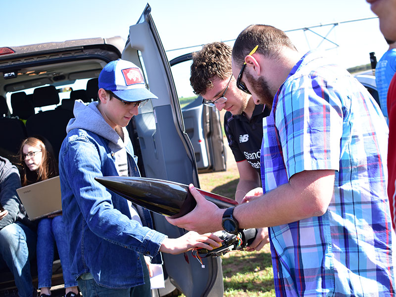 Members of the Husker Rocketry Team do a final inspection before take off.