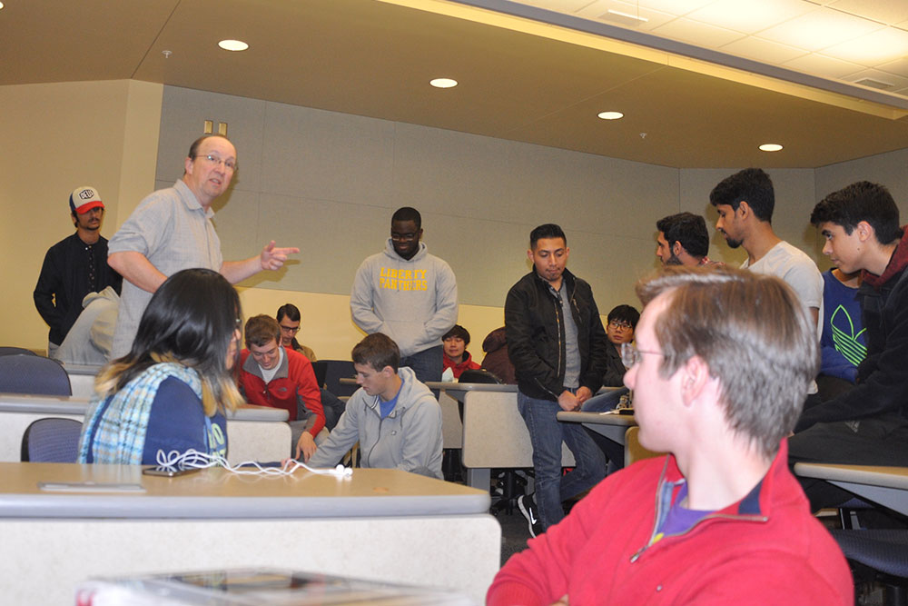 Mark Bauer, professor of practice in Electrical and Computer Engineering, instructs ELEC 121 students before they begin work on creating a device to shoot a rubber band from inside a three-sided box.