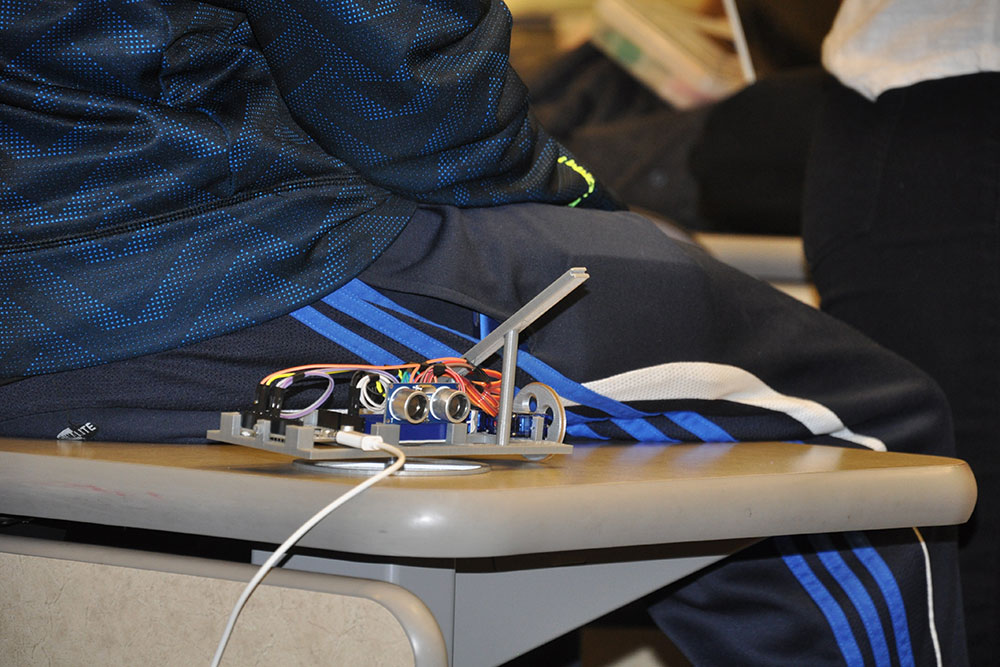 Devices like this one were created by students in ELEC 121 for the purpose of shooting a rubber band from inside a three-sided box.