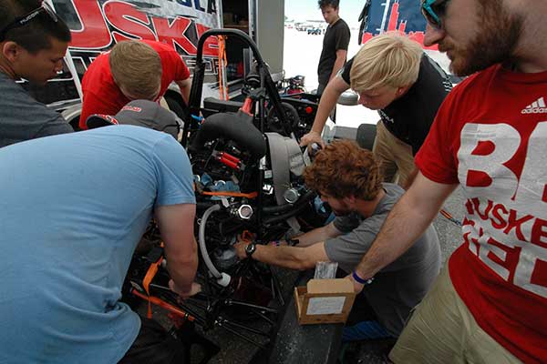 Husker Motorsports teammates work to repair the clutch on the car before Friday's autocross competition during the Formula SAE Lincoln event at Lincoln Airpark June 17-20.