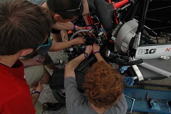 Husker Motorsports teammates work to repair the clutch on the car before Friday's autocross competition during the Formula SAE Lincoln event at Lincoln Airpark June 17-20.