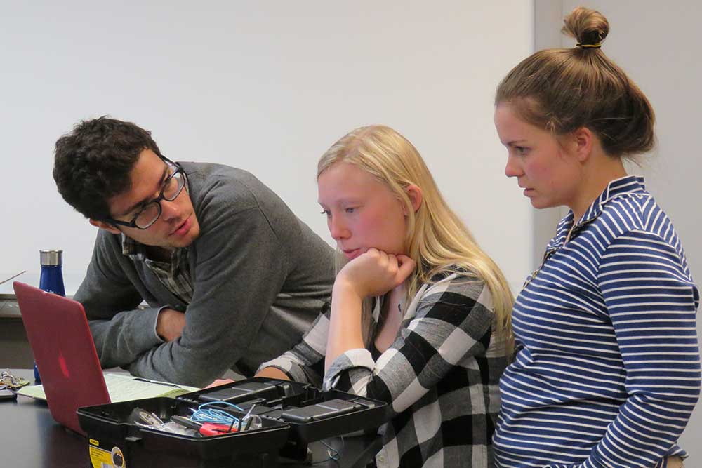 During a senior design capstone team meeting, biological systems engineering students (from left) Ravi Raghani, Emilie Johnson and Jordan Verplank discuss the redesign of a toy electric car that will enable mobility challenged toddlers to have more autonomy over their movements.