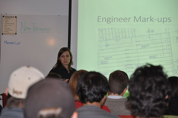 UNL engineering students listen as Kristi Schmit, a 2011 civil engineering graduate, explains the work she does at the Nucor Detailing Center in Norfolk on Oct. 9.