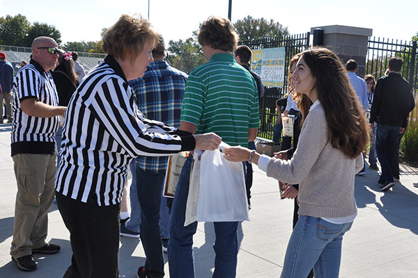 Members of the Norfolk Area Economic Development Council hand out welcome bags to UNL engineering students at Veterans Memorial Field in Norfolk on Oct. 9.