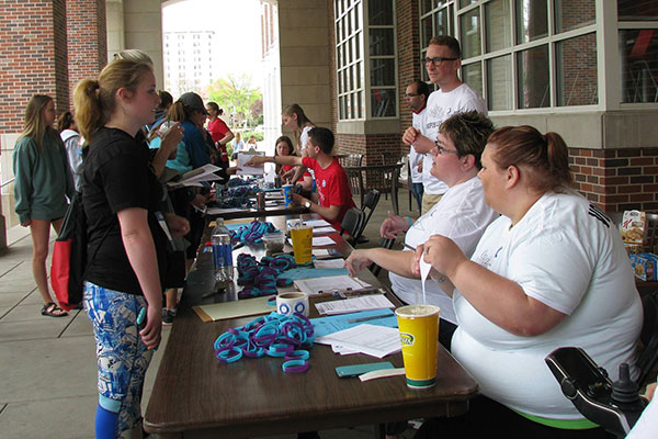 One of the 600 walkers who participated in the April 17 Out of the Darkness Campus Walk, registers at a table north of the Nebraska Union.