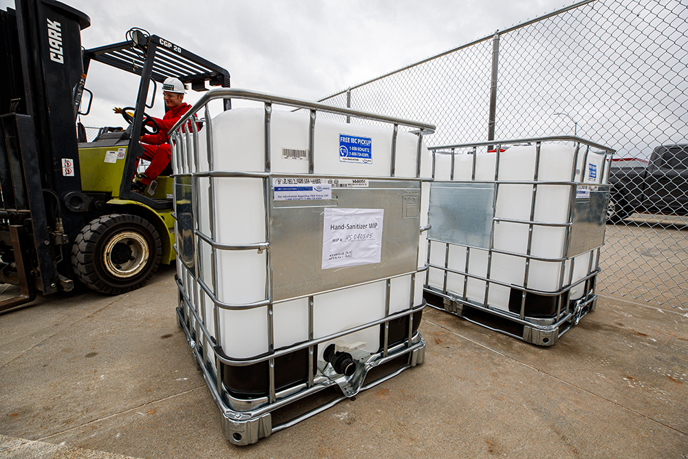 Russell Parde uses a forklift to move containers of chemicals being used to produce hand sanitizer. (Craig Chandler / University Communication)