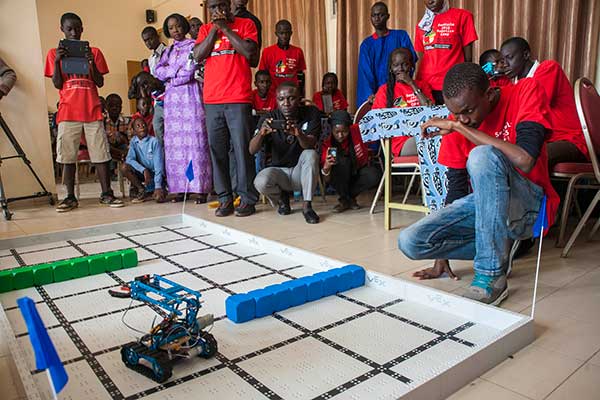A male student studies the movements of his team's robot during the third day of the SenEcole robotics camp in Dakar, Senegal this past March.