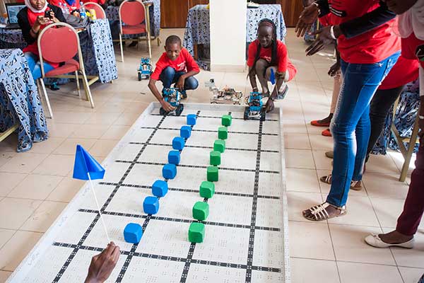 Two students prepare to race their robots during the third and final day of the SenEcole robotics camp in Dakar, Senegal this past March.