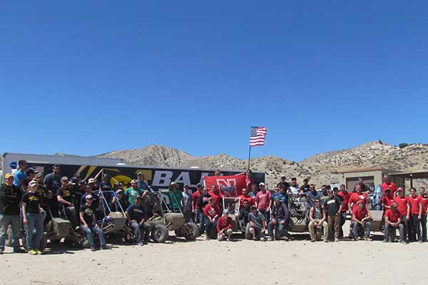 The Husker Racing Baja SAE team (center with flag) was one of six teams from Big Ten schools at last weekend's event in Gorman, California. Other teams (from left) were from Iowa, Michigan, Michigan State, Purdue and Wisconsin.
