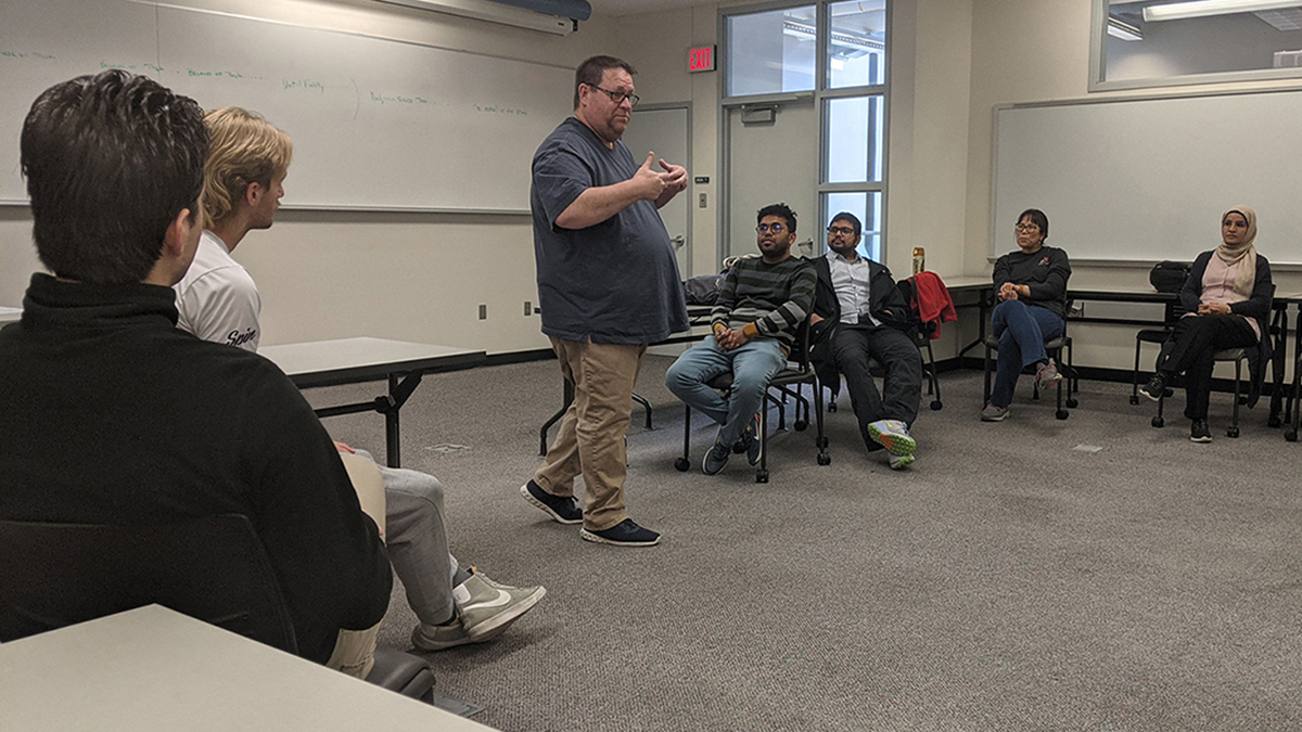 Doug Rothgeb, artistic director of Big Canvas improvisational troupe, discusses techniques for success when talking before an audience during a class on Scott Campus in Omaha.