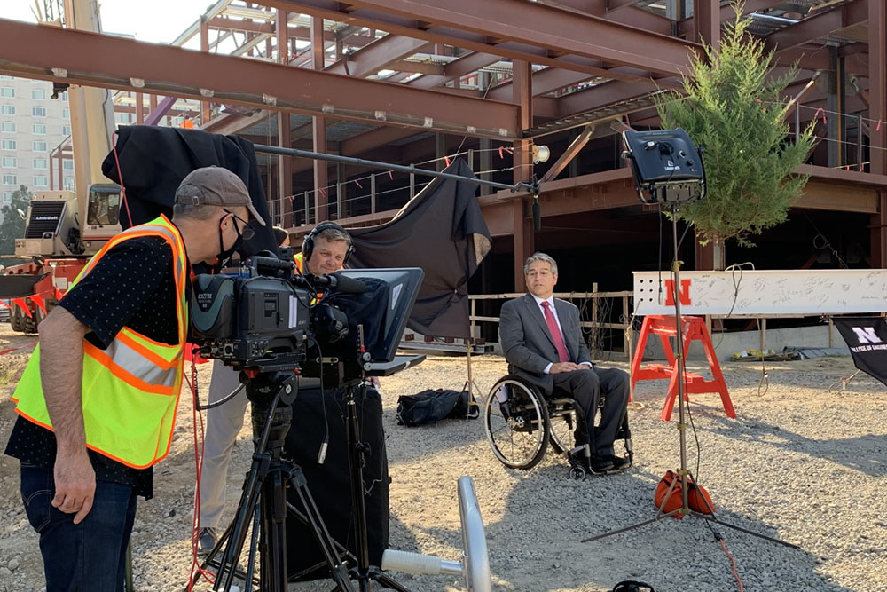 College of Engineering Dean Lance C. Pérez records a video message before the Topping Out ceremony for Phase 1 of the college's construction project.