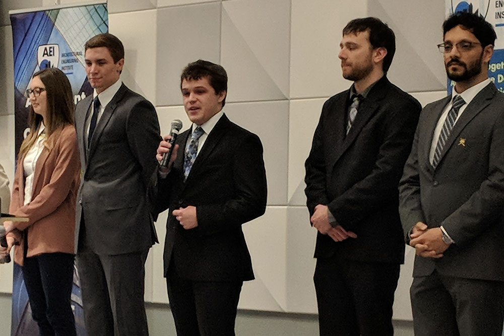 Jonathan Ingram (center) begins the Nebraska team proposal presentation during the during the Architectural Engineering Institute (AEI) Forum Student Design Competition April 5 at Scott Conference Center in Omaha.