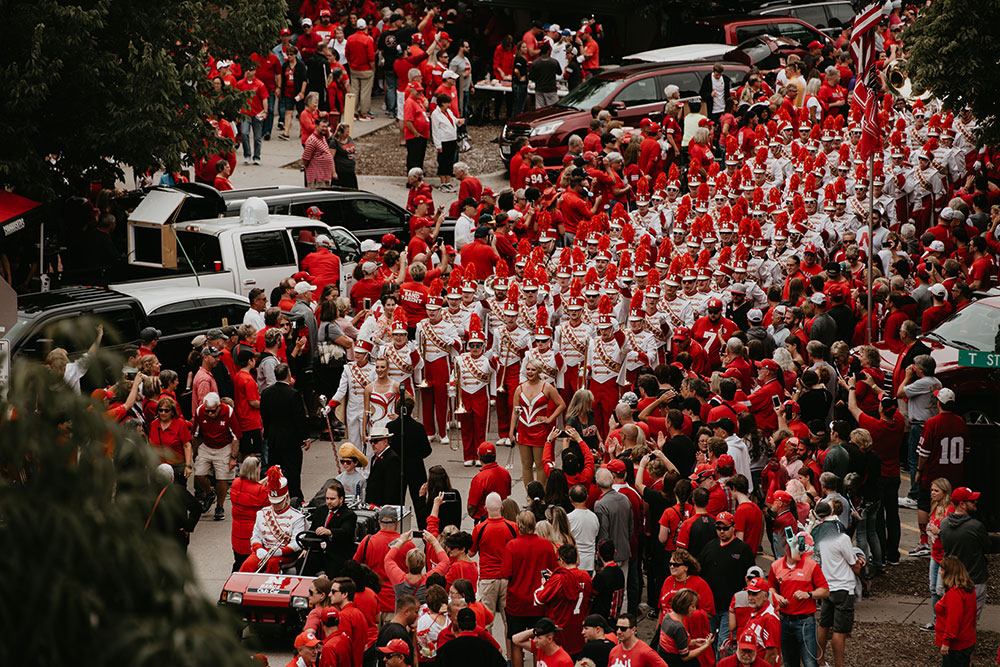 Featured twirler Kimberly Law is among the 32 engineering students in the Cornhusker Marching Band, seen here as it marches down Stadium Drive before the Sept. 8 game. (Photo by Justin Mohling)