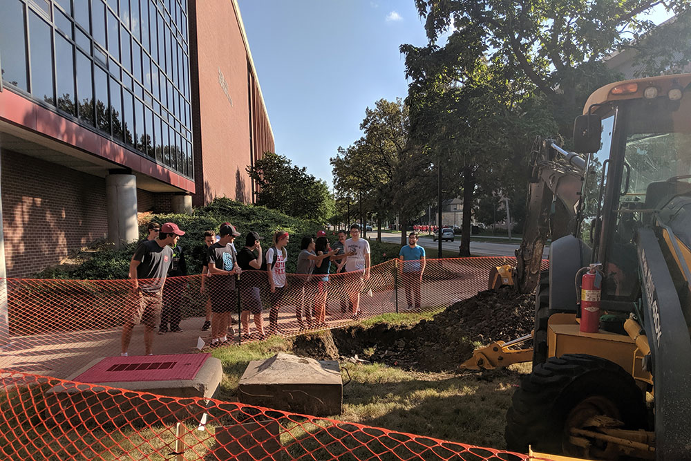 Students gather outside the Scott Engineering Center Link before the time capsule is unearthed.